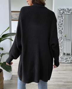 Detailed back view of a black chunky knit sweater featuring high neck and ribbed cuffs