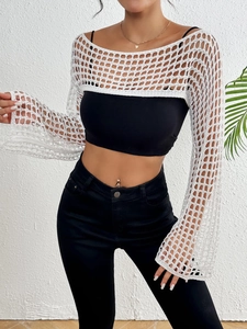 Detailed macro view of white crochet mesh fabric with loose weave and long sleeves texture