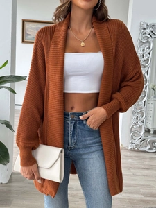 Detail view of caramel knitted cardigan with ribbed texture and long sleeves for women
