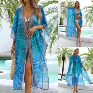 Detail of blue bohemian beach cover-up with abstract print and sheer chiffon texture