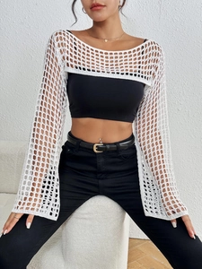 Close-up of white crochet mesh shrug with intricate square grid weave and flared sleeves
