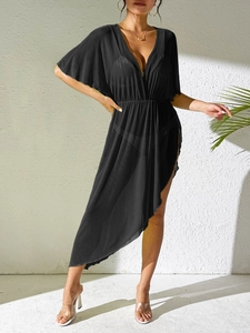 Detail of sheer black beach cover-up featuring deep V-neck and high elastic waist