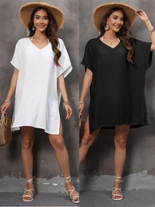 Detail showing V-neckline and side slit of the loose beach cover-up dress in black and white