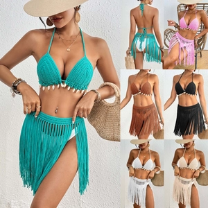 Detail of crochet bikini set with shell trim and fringe skirt in multiple colors