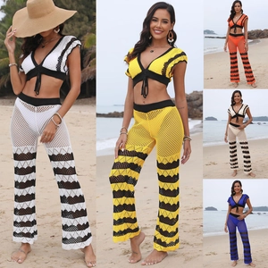Detail of crochet beach set featuring V-neck lace-up top and flare pants in various colors