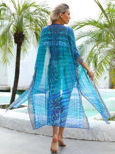 Back view of a long blue bohemian beach cover-up with mixed leopard and geometric prints