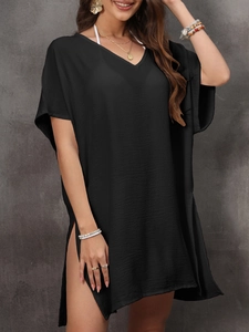 Detail of black V-neck beach cover-up featuring crinkle fabric and high side slits