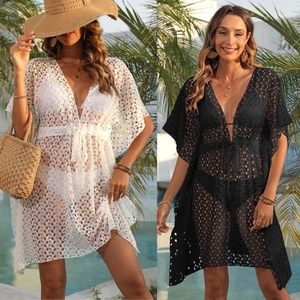Detail of crochet lace beach cover-up featuring V-neckline and waist drawstring ties