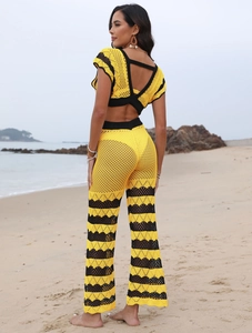 Women's beach crochet two-piece set featuring contrast color crop top and flared pants