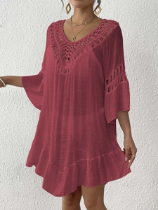 Close-up of crochet hollow embroidery and deep V-neck detail on the burgundy beach dress