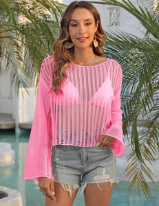 Detail of neon pink crochet hollow out top featuring flared sleeves and knit texture