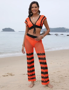 Close-up of knit crochet texture and wavy pattern on the orange beach set top