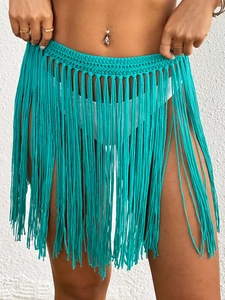 Detail of teal hand-crocheted beach cover-up skirt with long bohemian fringe tassels