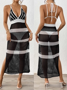 Detail of crochet knit beach cover-up featuring black and white contrast stripes and side slit