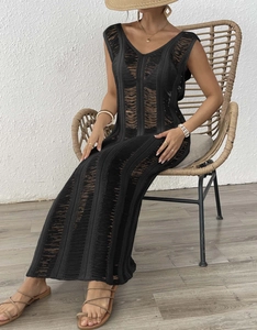 Close-up of black sleeveless knit maxi dress with geometric hollow-out pattern and V-neck