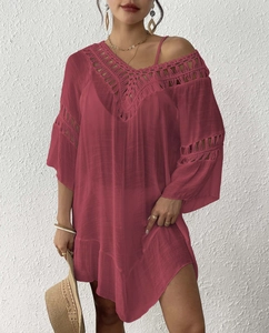 Detail view of burgundy beach cover-up with crochet lace neck and natural fabric texture