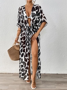Women's cow print long beach cover up with tie waist and flared sleeves on model