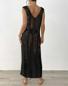 Detail of black hollow out beach cover up dress showing deep V-back design and texture