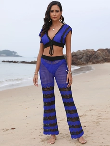 Detail view of the knit crochet texture and black wave pattern on blue beach set