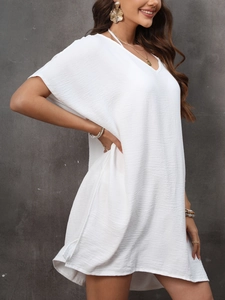 Detail of white V-neck beach cover-up dress in lightweight textured fabric for summer