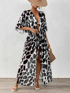 Detail of long sheer black and white cow print beach cover-up with waist tie belt