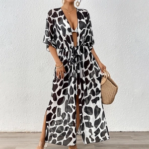 Detail of adjustable waist drawstring and black and white pattern on a beach cover-up