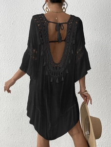 Detail showing the backless V-neck design with crochet lace and fringes on beach cover-up