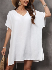 Close-up of white V-neck beach cover-up showing pleated texture and side slit detail