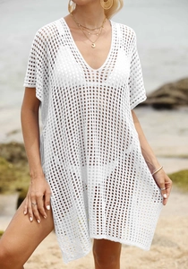 Detailed knit texture of white crochet beach cover-up with hollow mesh and V-neckline
