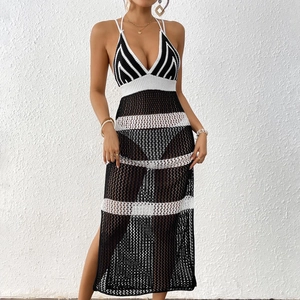 Detail of crochet knit beach cover-up featuring black and white striped hollow patterns