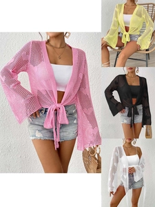 Detail of crochet cardigan showing heart knit patterns and bell sleeves in various colors