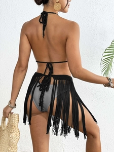 Detailed back view of a black hand-crocheted beach cover-up skirt with long tassels