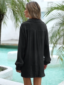 Detail of black crinkle fabric shirt back with pleated yoke for casual beach cover-up