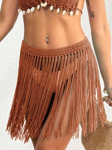 Detail of hand-crocheted fringe skirt with bohemian shell-embellished halter top