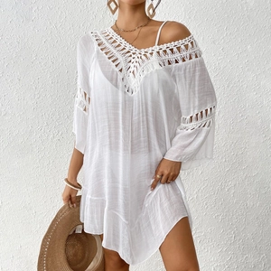 Detail of white crochet hollow-out lace patterns on the V-neck beach bikini cover-up dress