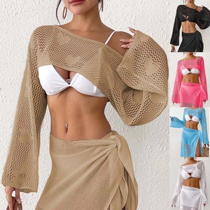 Close-up of heart crochet pattern and hollow knit texture on summer beach cover-up set