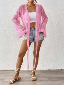Detail of pink crochet cardigan with hollow star pattern and long flared sleeves