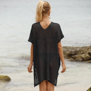 Detail of black hollow knit beach cover-up featuring a sexy open back and honeycomb mesh
