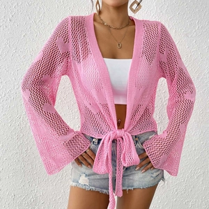 Macro detail of pink crochet knit cardigan with bell sleeves and front tie bow closure