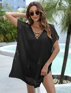 Detail view of black crochet beach cover-up featuring deep V-neck and lace-up design