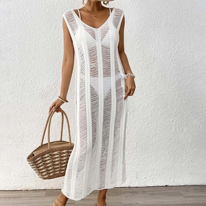 Detail of white sleeveless maxi dress featuring sheer cut-out texture for beach vacation