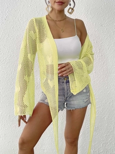 Detail of neon green crochet knit cardigan featuring flare sleeves and long tie closures