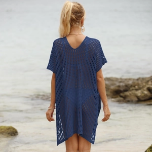 Detail of navy blue crochet beach cover-up featuring hollow-out mesh and V-neckline