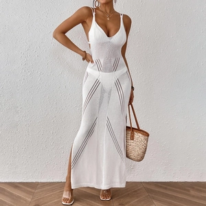 Close-up of white crochet knit texture and geometric hollow patterns on beach dress