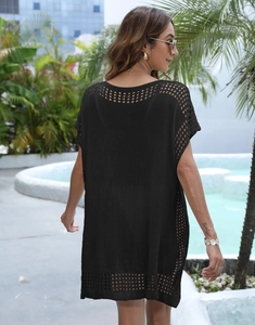 Detail of black hollow-out knitted beach cover-up showing back texture and pattern
