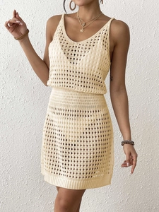 Detailed knit pattern of beige crochet two-piece set featuring hollow-out floral design