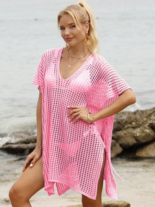 Detailed macro view of pink crochet beach cover-up with hollow knit diamond pattern