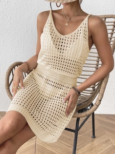 Detail of cream crochet knit two-piece set featuring hollow-out beach vacation style