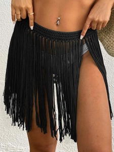 Detailed view of handmade black crochet beach cover-up skirt with elegant long tassels