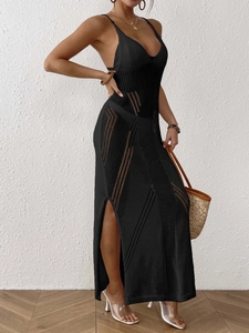 Detail of black knit maxi dress with side slits and delicate crochet hollow patterns